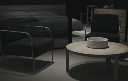 Dark elegant modern space featuring a sleek table and designer chairs